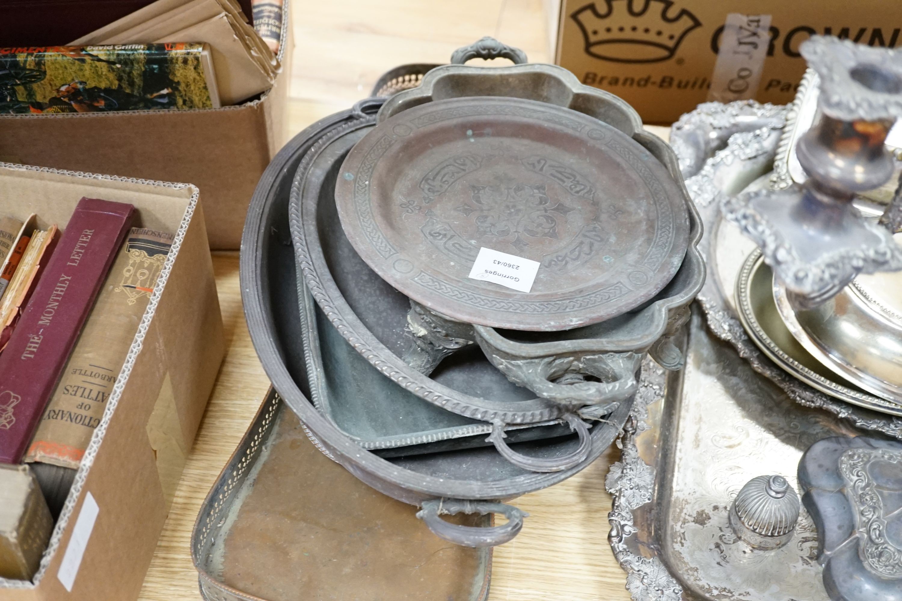 A large plated two handled tea tray, a circular salver, two galleried trays, two candelabrums and two entree dishes and covers, four metal tureens and a plate